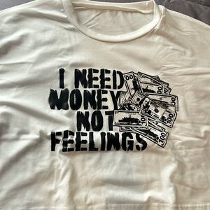 A white, oversized, cropped shirt with black printing at the front.